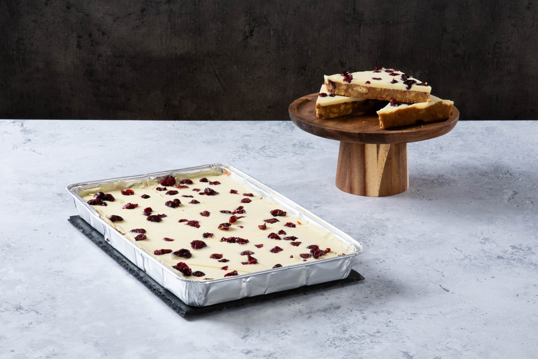 Cranberry blondie traybake with white chocolate topping.