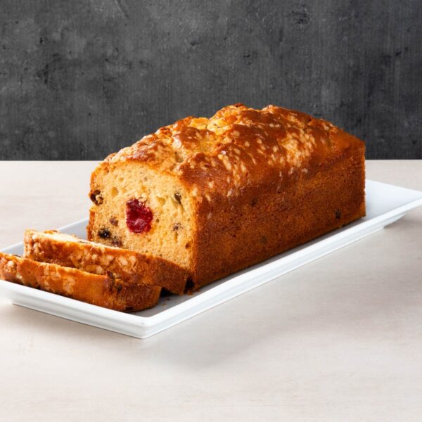 Sliced fruit and cherry loaf cake with glazed crust