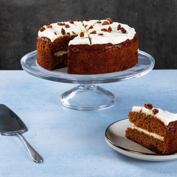 Carrot and sultana gateaux with cream icing and sliced piece.