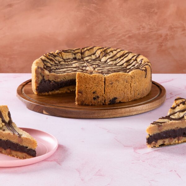 Sliced chocolate brownie cookie pie with drizzle topping