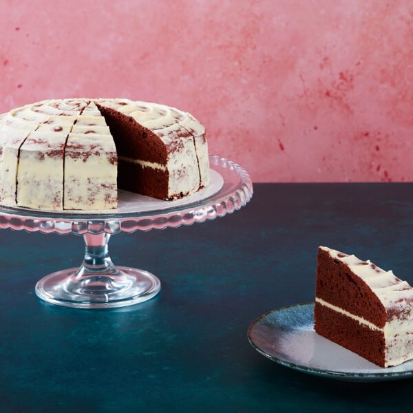 Red velvet cake with cream cheese frosting and red velvet crumbs.