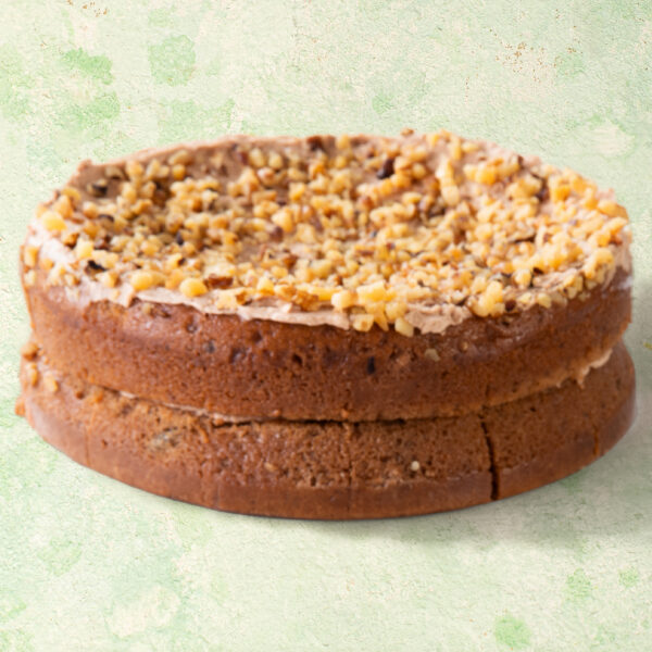 Vegan banana and cinnamon cake with chopped walnut topping