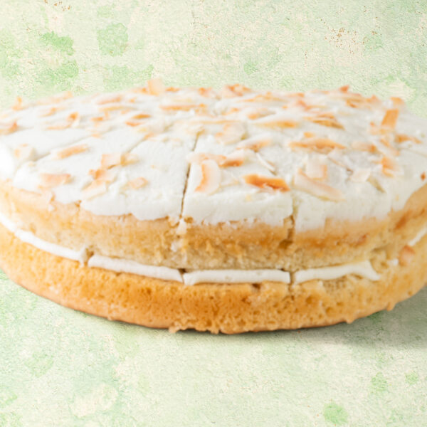 Vegan lime and coconut cake with coconut topping.