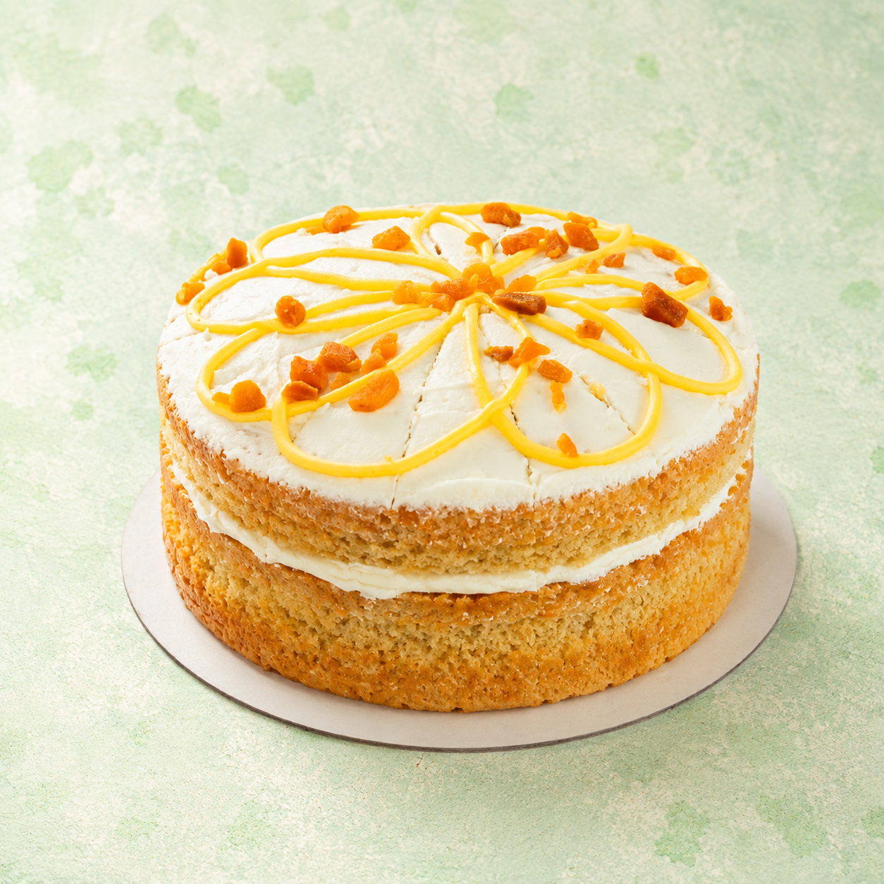 a double-layer cake with white frosting and orange topping